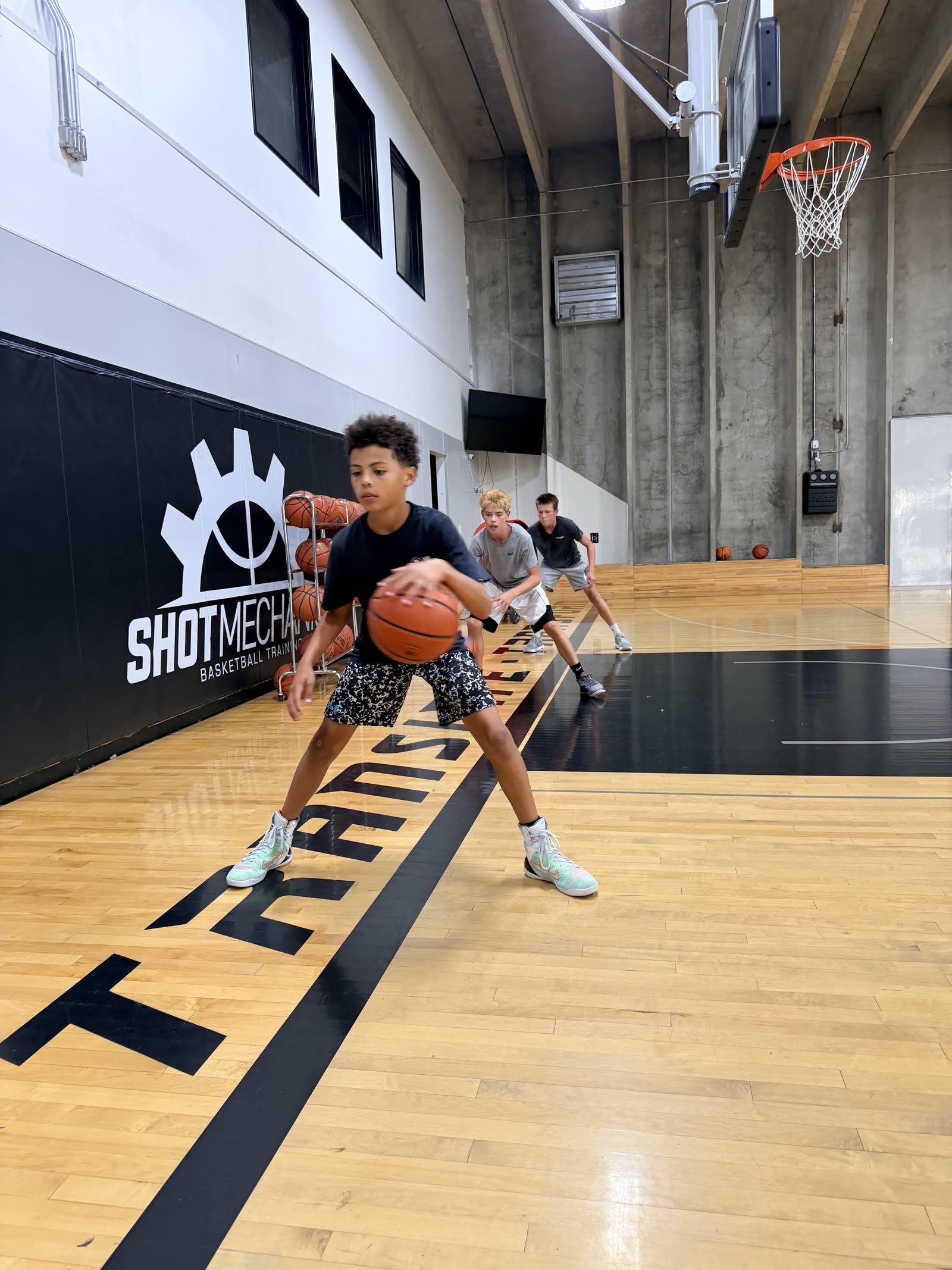 Player dribbling past defenders in a live group drill