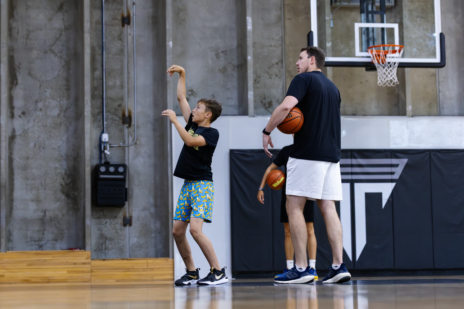 Coach feeding a player shooting reps in a private session